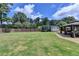 Spacious backyard featuring a shed, trampoline, and covered patio area, perfect for Gathering activities at 2410 Melton Common Dr, Dacula, GA 30019