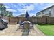 The backyard features a dining area and lush green grass at 2410 Melton Common Dr, Dacula, GA 30019