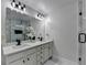 Elegant bathroom with large mirror, dual sinks and brushed black fixtures at 2410 Melton Common Dr, Dacula, GA 30019