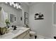 Cozy half bathroom with bright vanity, decorative shelves, and stylish framed wall art at 2410 Melton Common Dr, Dacula, GA 30019