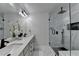 Elegant bathroom with large mirror, dual sinks, and walk-in shower with mosaic tiles at 2410 Melton Common Dr, Dacula, GA 30019