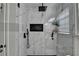 Sleek bathroom shower featuring black hardware, a niche, and marble-style tiling at 2410 Melton Common Dr, Dacula, GA 30019