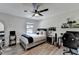 Neutral bedroom design featuring a ceiling fan, desk, and a comfortable bed at 2410 Melton Common Dr, Dacula, GA 30019