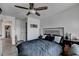 This bedroom features a ceiling fan, and a cool color pallet with wood laminate flooring at 2410 Melton Common Dr, Dacula, GA 30019