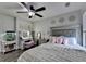Comfortable bedroom with a well-lit vanity, plush bedding, and modern decor at 2410 Melton Common Dr, Dacula, GA 30019