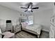 Cozy bedroom featuring a stylish bed, bedside tables, and a ceiling fan at 2410 Melton Common Dr, Dacula, GA 30019
