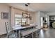 Cozy dining room with rustic table, bench, and chairs, bathed in natural light, providing an intimate dining space at 2410 Melton Common Dr, Dacula, GA 30019