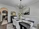 Tastefully designed dining room with modern chandelier, elegant decor, and a chic black display cabinet at 2410 Melton Common Dr, Dacula, GA 30019
