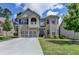 Beautiful two-story brick home with a well-manicured lawn and attached two-car garage at 2410 Melton Common Dr, Dacula, GA 30019