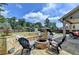 Inviting outdoor space featuring a custom stone fire pit with built-in seating and a beautifully landscaped backyard at 2410 Melton Common Dr, Dacula, GA 30019