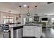 Bright kitchen with island seating, stainless steel appliances, and an open floor plan, perfect for entertaining guests at 2410 Melton Common Dr, Dacula, GA 30019