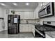 Kitchen features stainless steel appliances, white cabinets, granite countertops, and a subway tile backsplash at 2410 Melton Common Dr, Dacula, GA 30019