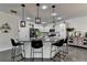 Modern kitchen features white cabinets, granite countertops, stainless steel appliances, and a large center island with bar stools at 2410 Melton Common Dr, Dacula, GA 30019