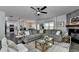 Open-concept living room featuring a large comfortable sofa and a stone fireplace at 2410 Melton Common Dr, Dacula, GA 30019