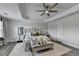 Bright main bedroom with decorative tray ceiling, ceiling fan, and neutral colors at 2410 Melton Common Dr, Dacula, GA 30019