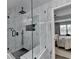 Walk-in shower with marble style and black hardware, conveniently located to bedroom at 2410 Melton Common Dr, Dacula, GA 30019