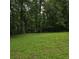 A view of the lush green backyard with mature trees at 3025 Butler Creek Nw Rd, Kennesaw, GA 30152