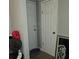 A hallway with two closed doors and items piled in the corner at 3025 Butler Creek Nw Rd, Kennesaw, GA 30152