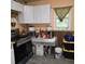 View of a kitchen with cabinets, appliances, and wood flooring at 3025 Butler Creek Nw Rd, Kennesaw, GA 30152