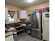 Functional kitchen featuring stainless steel refrigerator and upper cabinets at 3025 Butler Creek Nw Rd, Kennesaw, GA 30152