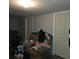 A cluttered living room with a large chair, clothing, and personal items at 3025 Butler Creek Nw Rd, Kennesaw, GA 30152