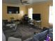 View of a living room with sofas, television, fan, and wood flooring at 3025 Butler Creek Nw Rd, Kennesaw, GA 30152