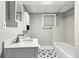 Bathroom featuring black star tile, tub and shower combination, and updated vanity at 428 Medlock Rd, Decatur, GA 30030