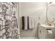 Bathroom featuring a shower with a patterned curtain, a sink with chrome hardware, and a round mirror at 428 Medlock Rd, Decatur, GA 30030