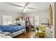 Bedroom features hardwood flooring, a ceiling fan, and ample natural light from large windows at 428 Medlock Rd, Decatur, GA 30030