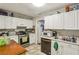 Well-lit kitchen featuring white cabinets, modern appliances, and plenty of counter space at 428 Medlock Rd, Decatur, GA 30030
