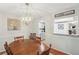 Well-lit dining room features a modern chandelier and pass-through to the kitchen at 67 Middleton Se Ct, Smyrna, GA 30080