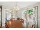 Charming dining area with natural light, wooden table, and stylish chandelier offering a comfortable setting at 67 Middleton Se Ct, Smyrna, GA 30080