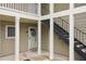 Covered entryway with white columns, black staircase, and decorated front door at 67 Middleton Se Ct, Smyrna, GA 30080