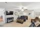 Cozy living room with a ceiling fan, soft carpet, a modern TV and an entrance to the dining area at 67 Middleton Se Ct, Smyrna, GA 30080