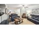 Inviting living room is furnished with leather couches, a ceiling fan, and a wood coffee table at 67 Middleton Se Ct, Smyrna, GA 30080