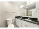 Bathroom with double sink vanity, black granite countertop, and tiled shower with glass door at 1386 Heritage Glen Dr, Marietta, GA 30068