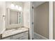 Half bathroom with granite vanity and tile floors, conveniently located near the main living areas at 1386 Heritage Glen Dr, Marietta, GA 30068