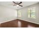 Bedroom with hardwood floors, neutral paint, two windows providing natural light and a ceiling fan at 1386 Heritage Glen Dr, Marietta, GA 30068