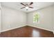 Cozy bedroom with hardwood floors, neutral paint, and a bright window offering views of the outdoors at 1386 Heritage Glen Dr, Marietta, GA 30068