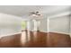 Spacious bedroom featuring hardwood floors, a ceiling fan, and natural light from a window at 1386 Heritage Glen Dr, Marietta, GA 30068