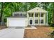 Charming two-story home with a two-car garage and a welcoming front porch surrounded by lush greenery at 1386 Heritage Glen Dr, Marietta, GA 30068