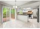 Eat in kitchen with white cabinets, stainless appliances, tile floor, and sliding doors to the deck at 1386 Heritage Glen Dr, Marietta, GA 30068