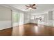 Open concept living area with hardwood floors, leading to the kitchen and a sliding glass door to the deck at 1386 Heritage Glen Dr, Marietta, GA 30068