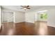 Spacious living room featuring hardwood floors, neutral walls, a ceiling fan and open archways to the dining area at 1386 Heritage Glen Dr, Marietta, GA 30068