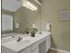Bathroom featuring a double sink vanity with white cabinetry and a large mirror at 2145 Charleston Oak Cir, Lawrenceville, GA 30043