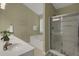 Bathroom featuring a double sink vanity, shower with glass doors and a tub at 2145 Charleston Oak Cir, Lawrenceville, GA 30043