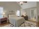 Vaulted ceiling bedroom showcasing hardwood floors, a ceiling fan, and natural light at 2145 Charleston Oak Cir, Lawrenceville, GA 30043