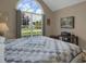 Bedroom featuring a large arch window, neutral walls and hardwood floors at 2145 Charleston Oak Cir, Lawrenceville, GA 30043