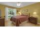 Comfortable bedroom featuring hardwood floors, a window with curtains and light color walls at 2145 Charleston Oak Cir, Lawrenceville, GA 30043