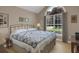 Cozy bedroom with hardwood floors, a large window, and neutral wall color at 2145 Charleston Oak Cir, Lawrenceville, GA 30043
